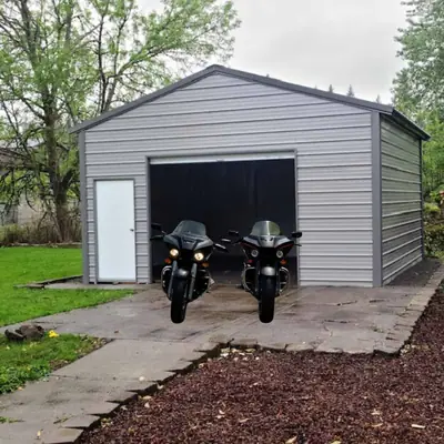 Enclosed garage with motorcycles out front