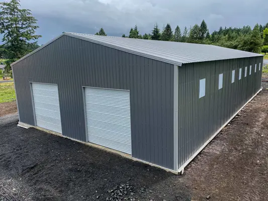 30x50 enclosed metal building with roll-up doors and windows