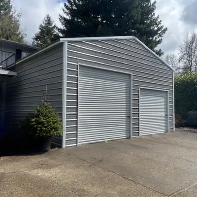 Gray enclosed garage with two roll-up doors