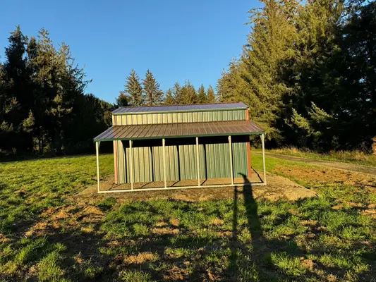 Barn-style garage with lean-tos on a grass site